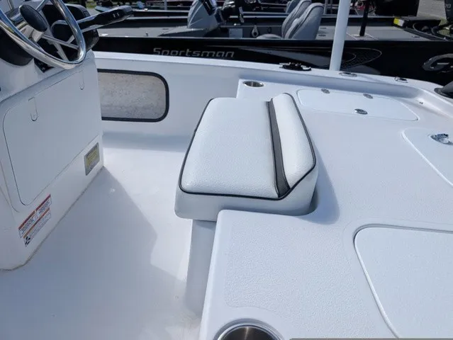 Slide: The Image of The image shows the cockpit of a 2025 ALK2 Powerboats 17 HS with white upholstery. - 19