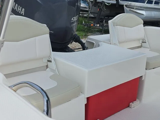 Slide: The Image of The image shows the seating area of a 2016 Robalo R160 Center Console boat with a Yamaha engine. - 16