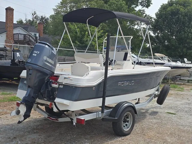 Slide: The Image of A 2016 Robalo R160 Center Console boat on a trailer with a Yamaha outboard motor. - 6