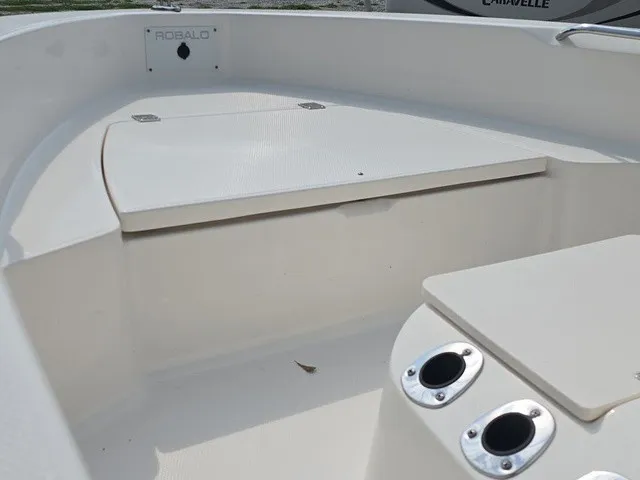 Slide: The Image of The image shows the deck of a 2016 Robalo R160 Center Console boat with storage space. - 23