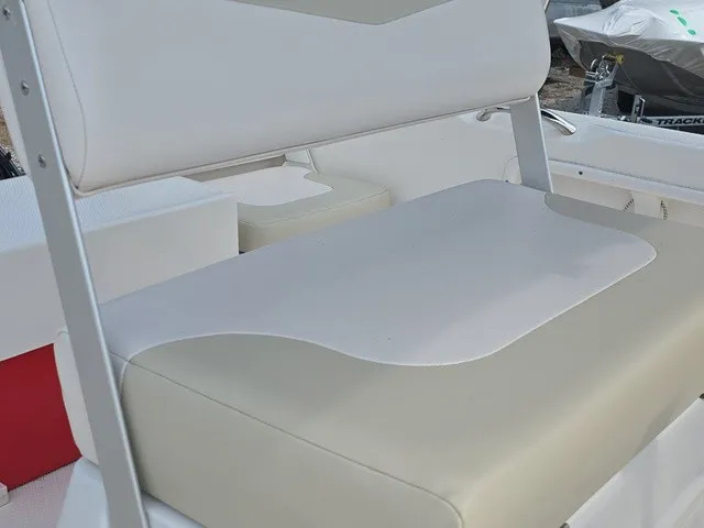 Slide: The Image of Close-up of a white and beige bench seat on a 2016 Robalo R160 Center Console boat. - 15