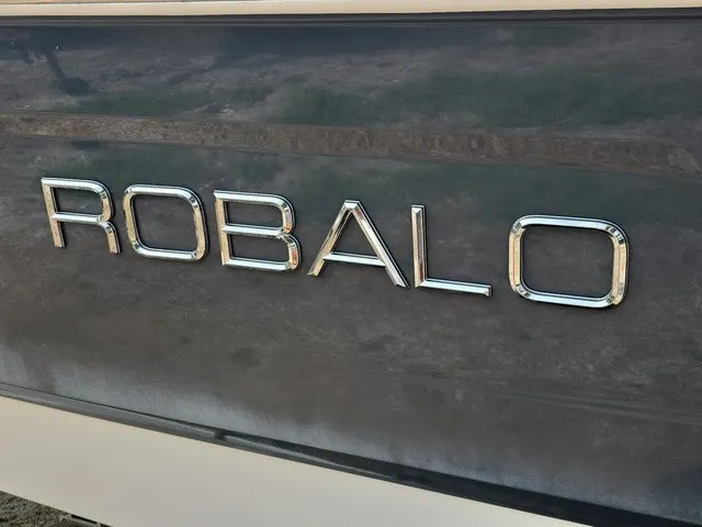 Slide: The Image of Close-up of the Robalo logo on a boat hull. - 27