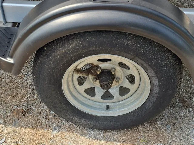 Slide: The Image of Close-up of a boat trailer wheel on gravel. - 26