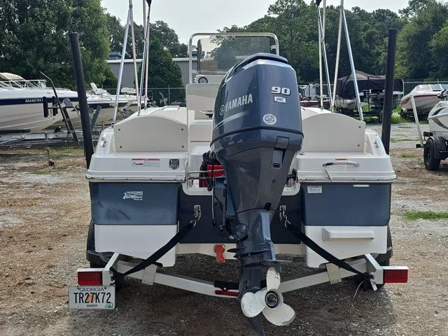 Slide: The Image of A 2016 Robalo R160 Center Console boat with a Yamaha 90 HP outboard motor on a trailer. - 7