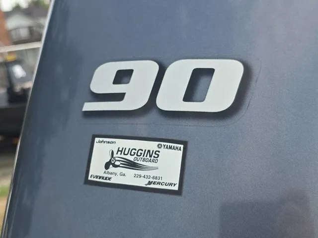 Slide: The Image of Close-up of an outboard motor with the number 90 and a dealer sticker. - 18