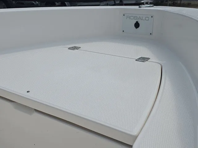 Slide: The Image of The image shows the bow deck of a 2016 Robalo R160 Center Console boat. - 13