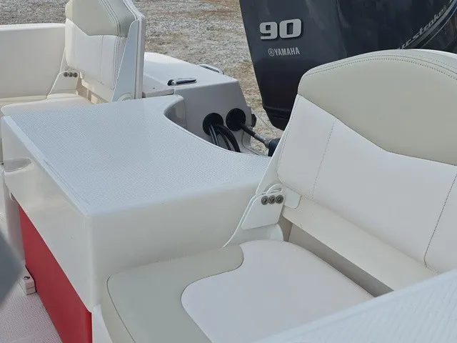 Slide: The Image of The image shows the seating of a 2016 Robalo R160 Center Console boat with a Yamaha 90 engine. - 20