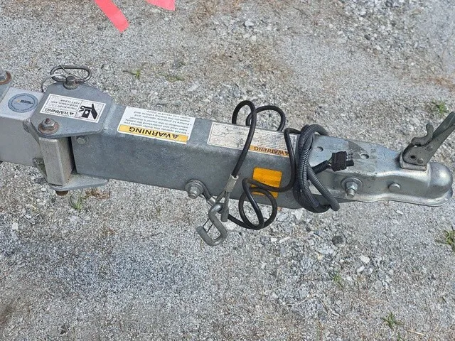 Slide: The Image of Close-up of a boat trailer hitch on gravel ground. - 11