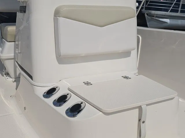Slide: The Image of The image shows the helm of a 2016 Robalo R160 Center Console boat with cup holders. - 29