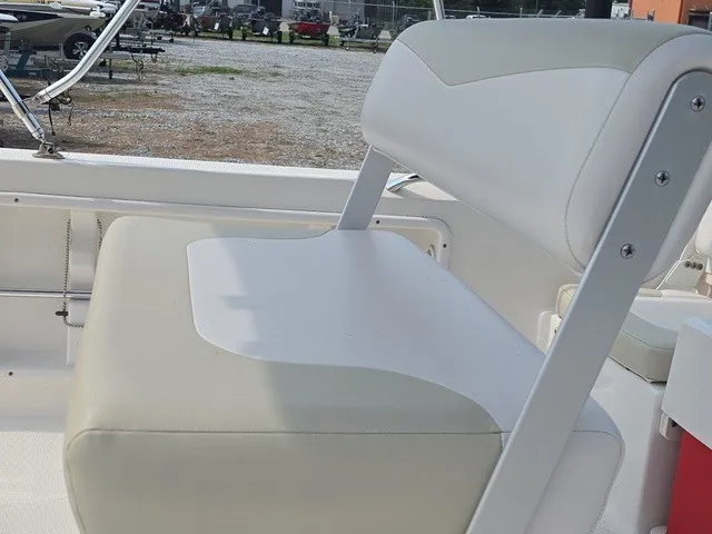 Slide: The Image of A white seat with gray accents on a boat, surrounded by other boats in the background. - 22