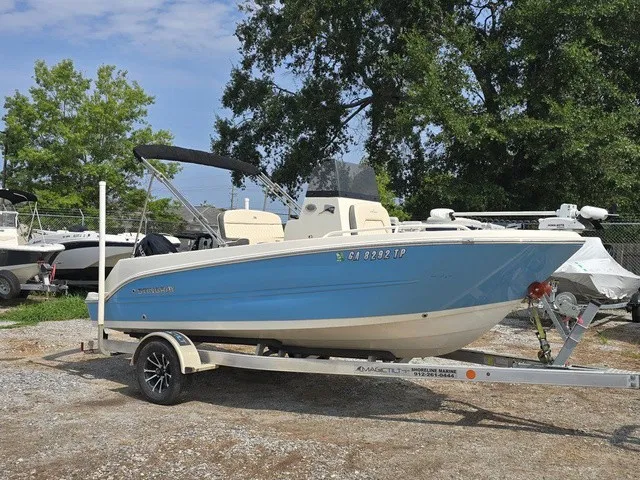 Slide: The Image of A blue 2023 Stingray 173 CC on a trailer, surrounded by trees and other boats. - 8