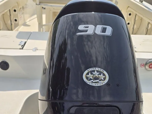 Slide: The Image of A black outboard motor labeled "90" with a low emissions emblem. - 15