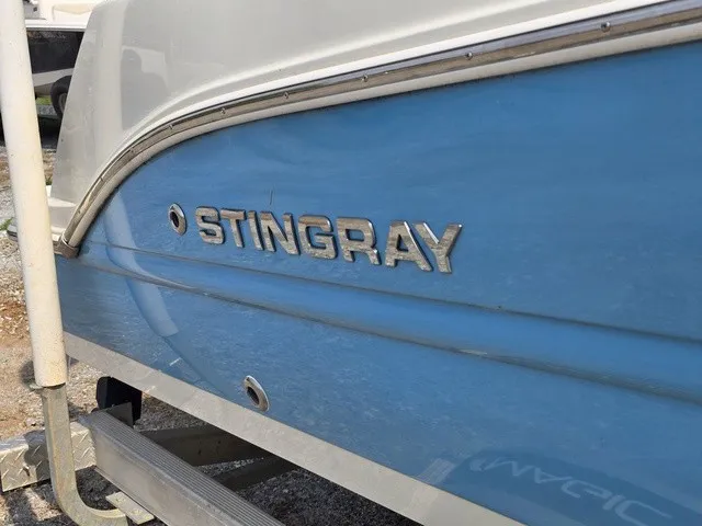 Slide: The Image of Close-up of a blue Stingray 173 CC boat hull with silver lettering. - 11