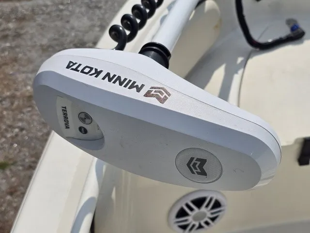 Slide: The Image of Close-up of a Minn Kota trolling motor on a boat, with a speaker in the background. - 29