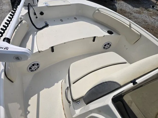 Slide: The Image of The image shows the cockpit of a 2023 Stingray 173 CC boat with white seating and speakers. - 28