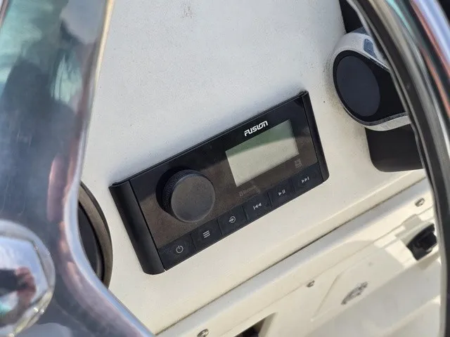 Slide: The Image of Close-up of a Fusion audio system on a boat, surrounded by a steering wheel. - 26