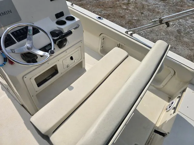 Slide: The Image of The image shows the cockpit of a 2023 Stingray 173 CC boat with a helm and bench seat. - 19