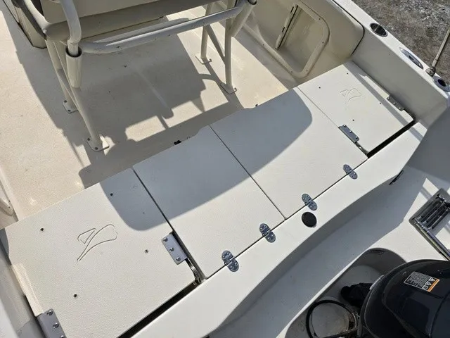 Slide: The Image of The image shows the cockpit of a Stingray 173 CC boat with white seating and storage areas. - 18
