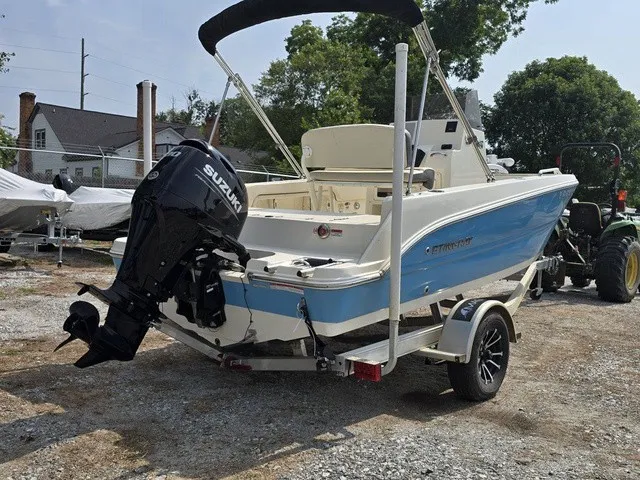 Slide: The Image of A 2023 Stingray 173 CC boat with a Suzuki outboard motor, parked on a trailer. - 6