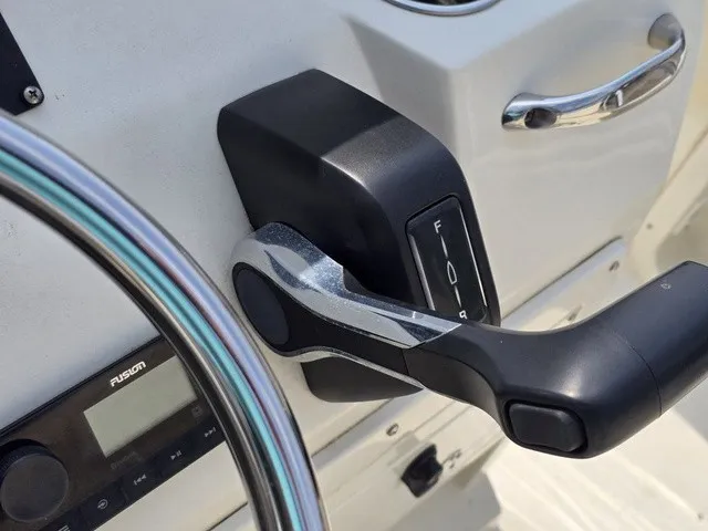 Slide: The Image of Close-up of the throttle lever and instruments on a 2023 Stingray 173 CC boat. - 25