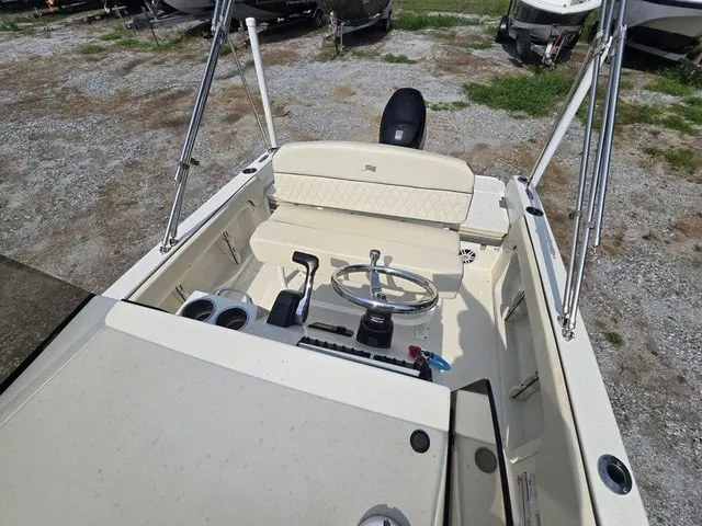 Slide: The Image of The image shows the cockpit of a 2023 Stingray 173 CC boat with steering and seating. - 34