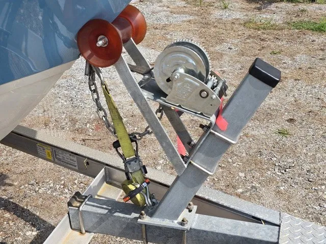 Slide: The Image of A boat trailer with a winch and safety strap securing a boat. - 9