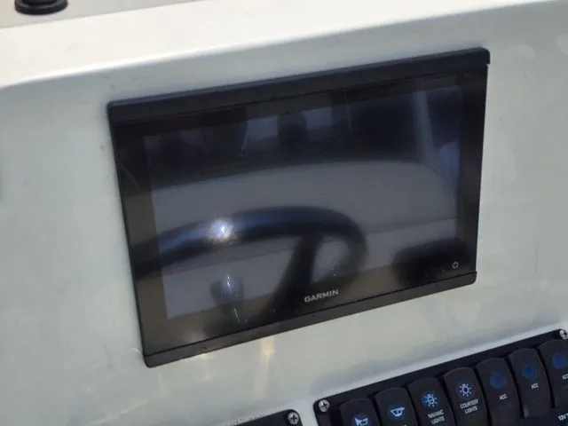 Slide: The Image of A Garmin screen is integrated into a boat's dashboard, surrounded by switches. - 21