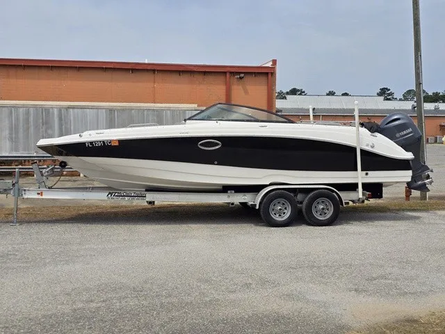 Slide: The Image of A white and black boat on a trailer, featuring an outboard motor. - 3