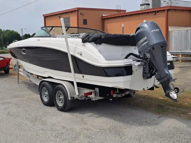 Slide: The Image of A 2022 NauticStar 243 DC boat on a trailer, featuring a Yamaha 200 outboard motor. - 4