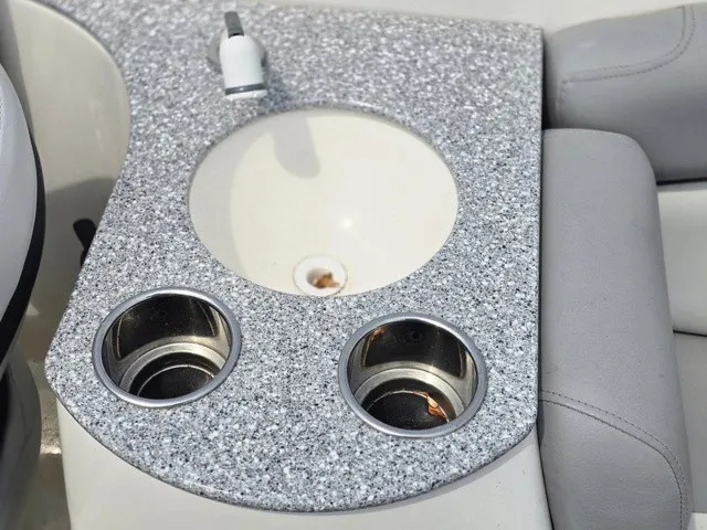 Slide: The Image of A gray granite cockpit table with an integrated sink and two cup holders. - 18