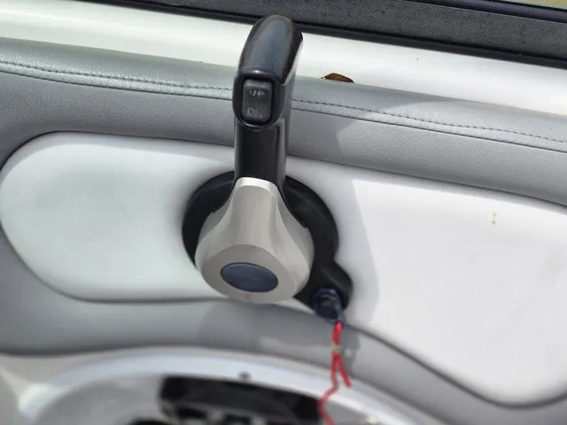 Slide: The Image of Close-up of a boat throttle lever with a gray and black design. - 26