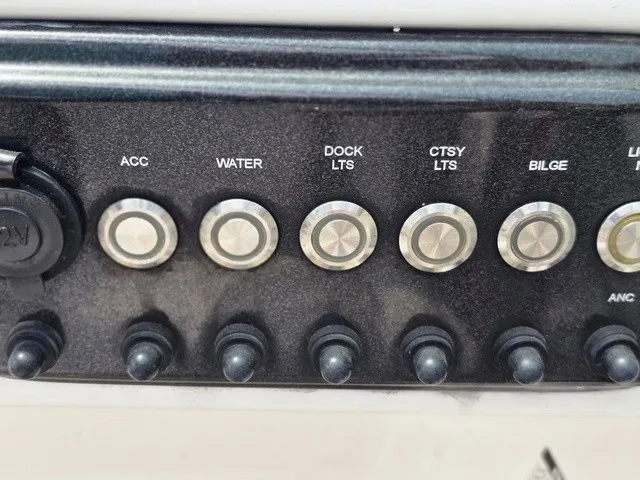 Slide: The Image of Close-up of a control panel with various toggle switches and buttons for boat controls. - 25