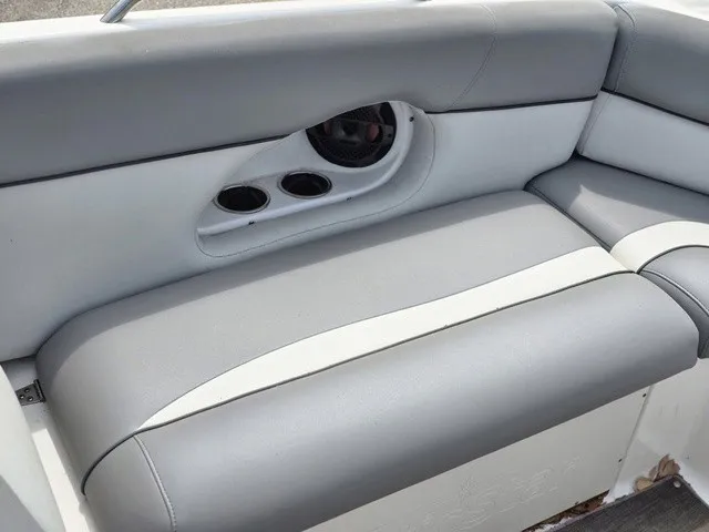 Slide: The Image of Gray and white cushioned bench with cup holders and speaker. - 11
