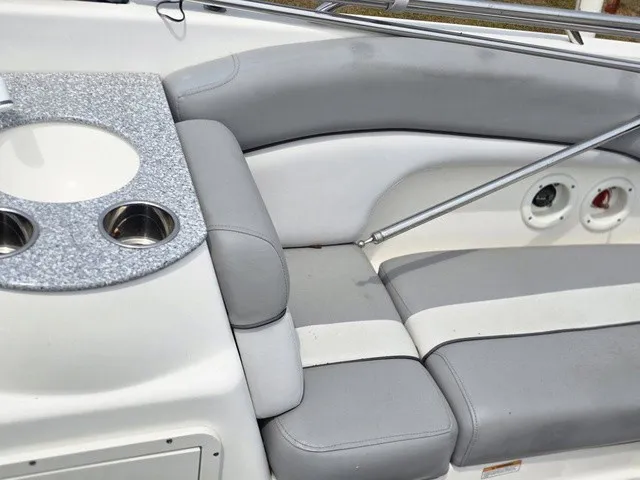 Slide: The Image of The image shows the gray and white seating of a 2022 NauticStar 243 DC. - 17