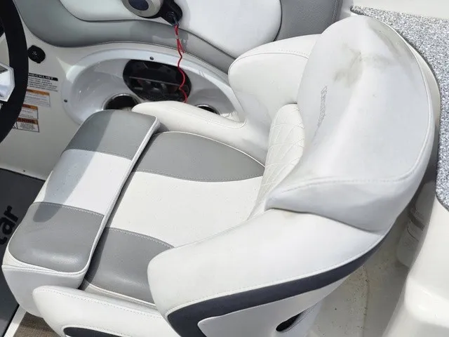 Slide: The Image of A luxurious, padded boat seat in white and gray with armrests and a speaker nearby. - 29