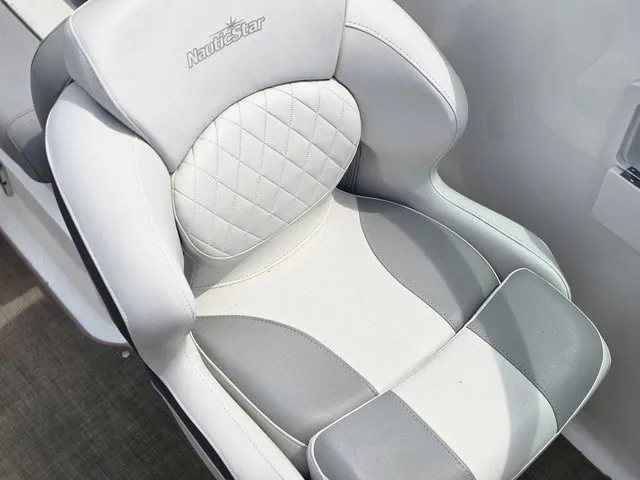 Slide: The Image of A sleek, padded seat in white and gray with the NauticStar logo on the backrest. - 31