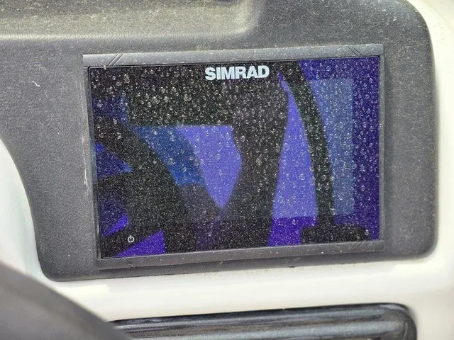 Slide: The Image of A Simrad screen on a boat, slightly covered with water droplets. - 24
