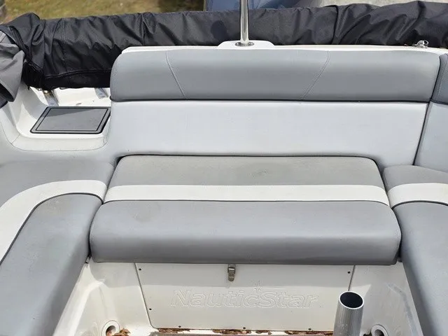 Slide: The Image of The gray cushioned seats on a NauticStar 243 DC boat provide comfortable seating in the aft area. - 19