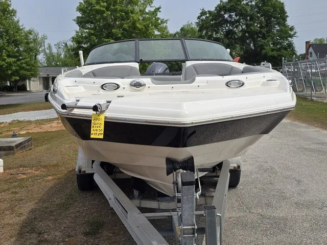 Slide: The Image of A white NauticStar 243 DC boat is on a trailer in a parking area. - 9