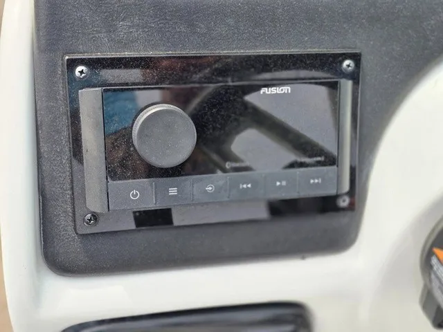 Slide: The Image of Close-up of a Fusion audio system on a 2022 NauticStar 243 DC boat. - 22