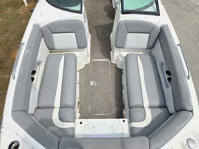 Slide: The Image of The image shows the cockpit of a 2022 NauticStar 243 DC with gray upholstery. - 13