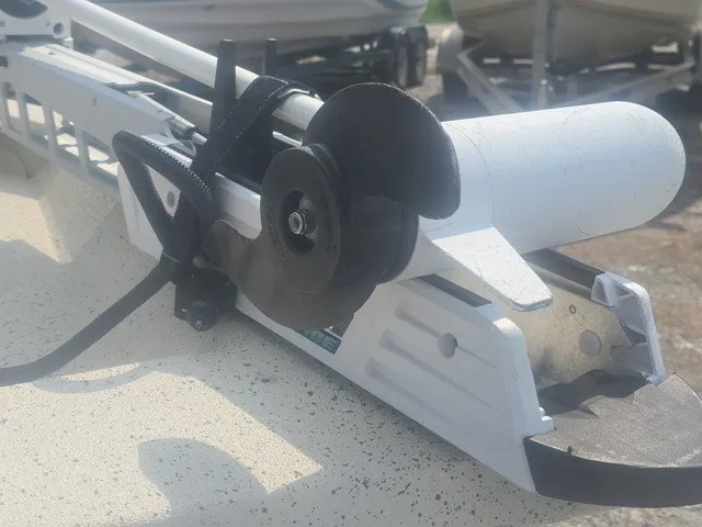 Slide: The Image of A white boat motor with a black propeller is mounted on a boat. - 32