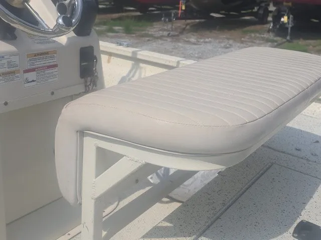 Slide: The Image of A white cushioned seat on a boat with a helm station in the background. - 14