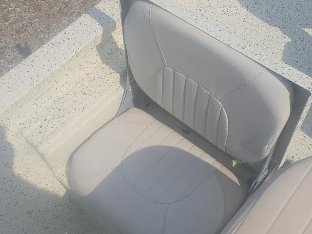 Slide: The Image of Seating area of a 2012 Xpress H22B Bay boat with cushioned seats. - 28