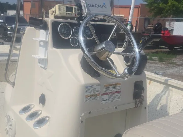 Slide: The Image of The image shows the helm of a 2012 Xpress H22B Bay boat with a Garmin device. - 15