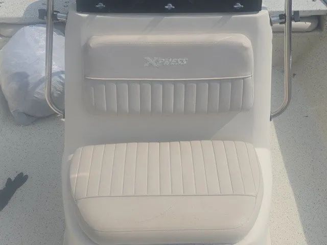 Slide: The Image of A cushioned seat with the Xpress logo on a boat. - 22