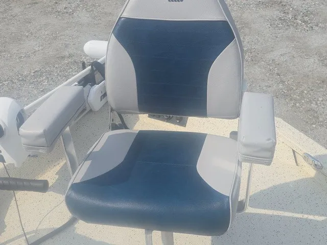 Slide: The Image of A cushioned boat seat in blue and gray on an Xpress H22B Bay boat. - 26