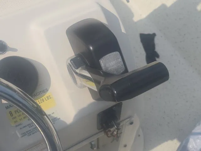 Slide: The Image of Close-up of a black control lever on a white boat. - 20