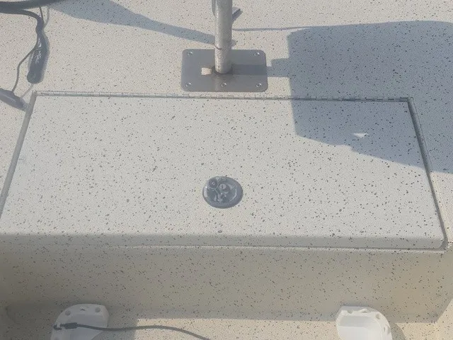 Slide: The Image of A gray, speckled deck of a 2012 Xpress H22B Bay boat with a metal mount. - 24