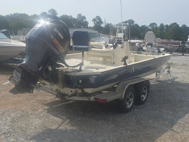 Slide: The Image of A 2012 Xpress H22B Bay boat with a Yamaha outboard motor, parked on a trailer. - 7